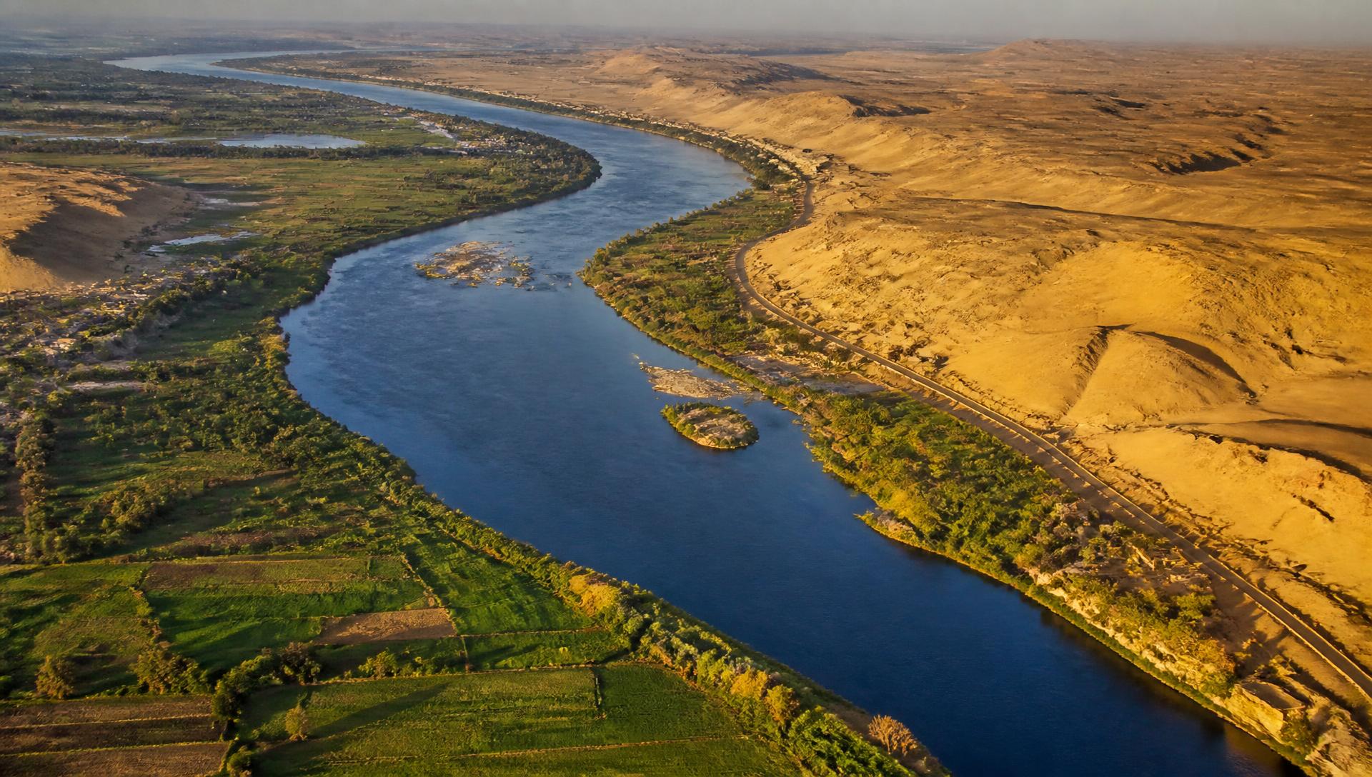 Aerial view of the Nile winding through green banks and desert